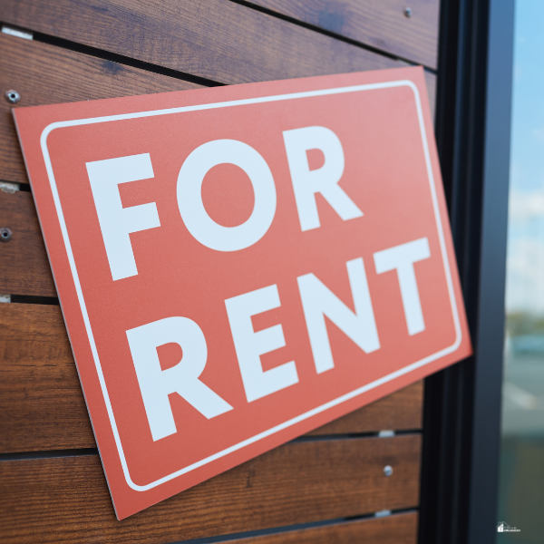 A "For Rent" sign is displayed on a wooden fence, indicating property availability.