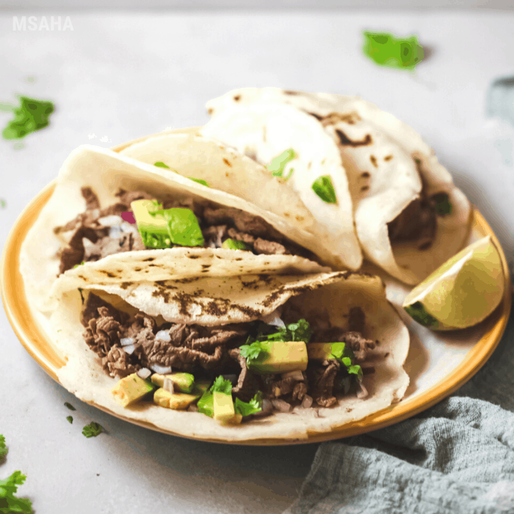 steak tacos with lime on the side