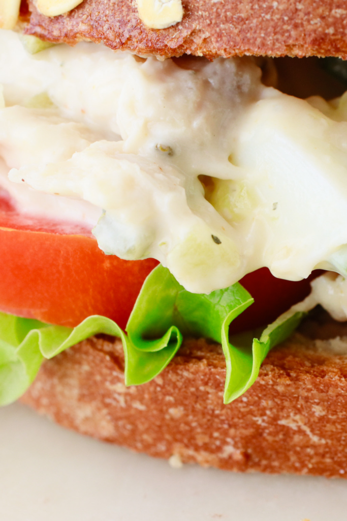 Homemade chicken salad sandwich with creamy chicken salad, fresh lettuce, and ripe tomato on whole-grain bread—perfect for an easy lunch or meal prep.