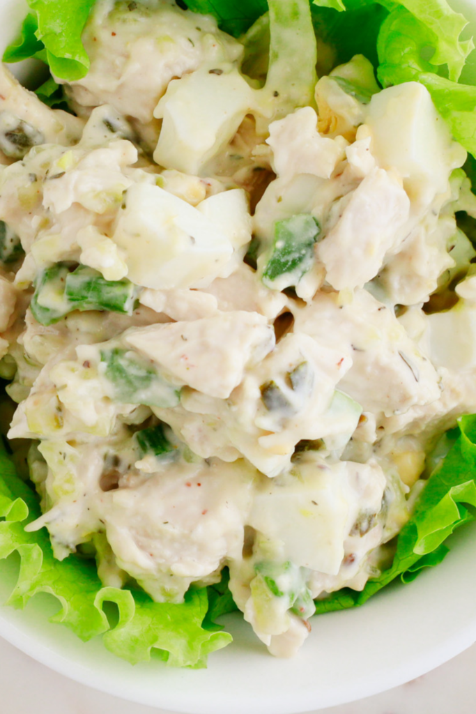 Creamy easy chicken salad recipe made with tender chicken, hard-boiled eggs, crunchy celery, and mayo, served on fresh lettuce—perfect for sandwiches, wraps, or a quick meal.