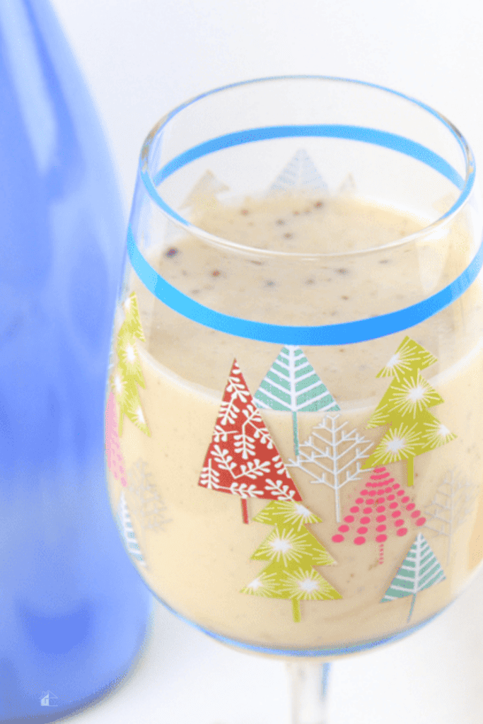 Holiday glass filled with coquito.