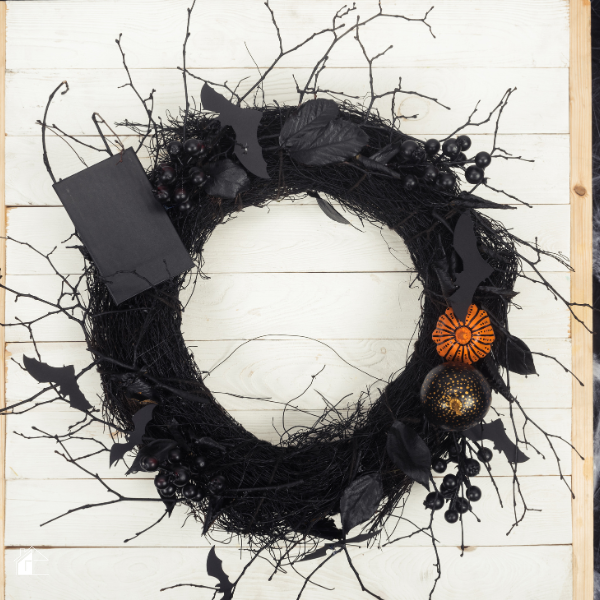 Elegant black Halloween wreath with bats, berries, and pumpkins, perfect for non-crafters looking for easy Halloween wreath ideas and spooky front door decor.