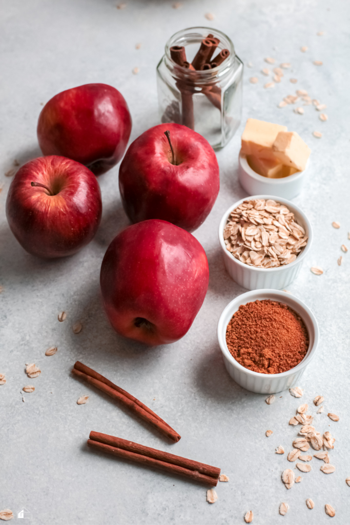 Ingredients for Instant Pot stuffed apples, including red apples, oats, cinnamon sticks, butter, and brown sugar, perfect for a quick and healthy fall dessert.