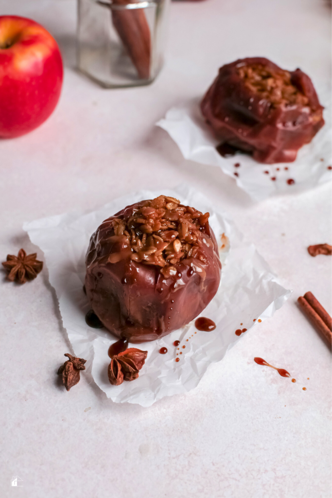 Close-up of a baked apple stuffed with oats and spices, drizzled with caramel, showcasing a warm and healthy fall dessert made in the Instant Pot.