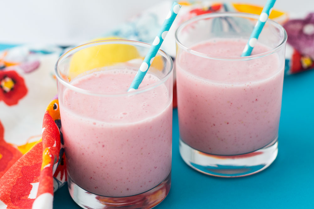 An image of two glasses of lemon strawberry smoothies.