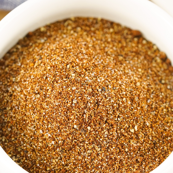 A bowl filled with a finely ground, easy chili seasoning recipe, showcasing a rich blend of spices like chili powder and cumin, ready to add bold flavor to your favorite dishes.