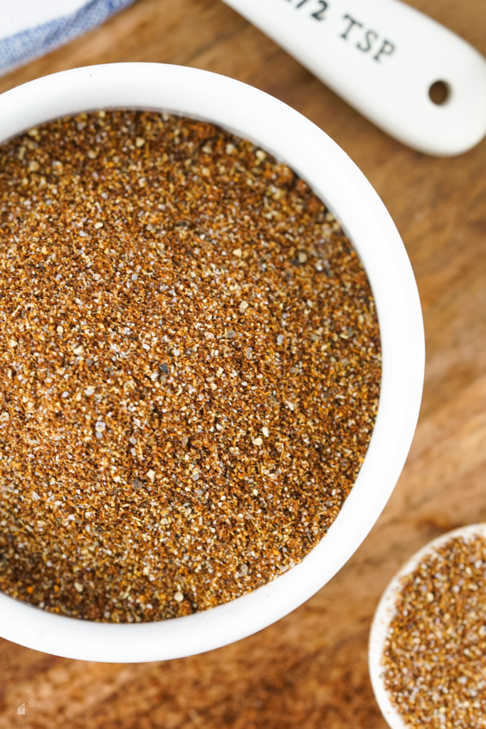 A close-up of a bowl filled with homemade chili seasoning, showcasing a finely mixed blend of spices including chili powder, cumin, and cayenne pepper, perfect for adding flavor to your favorite chili recipes.