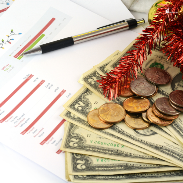 A holiday budget sheet with cash and coins, showing practical Christmas budget tips for families looking to enjoy Christmas on a budget.