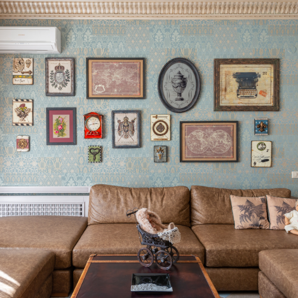 A living room with a vintage-style gallery wall and eclectic decor, demonstrating creative ways to incorporate outdoor-inspired artwork.