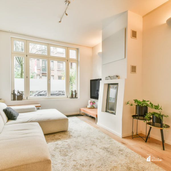 Bright and airy modern living room with neutral decor and natural light, perfect for budget-friendly home improvement inspiration.