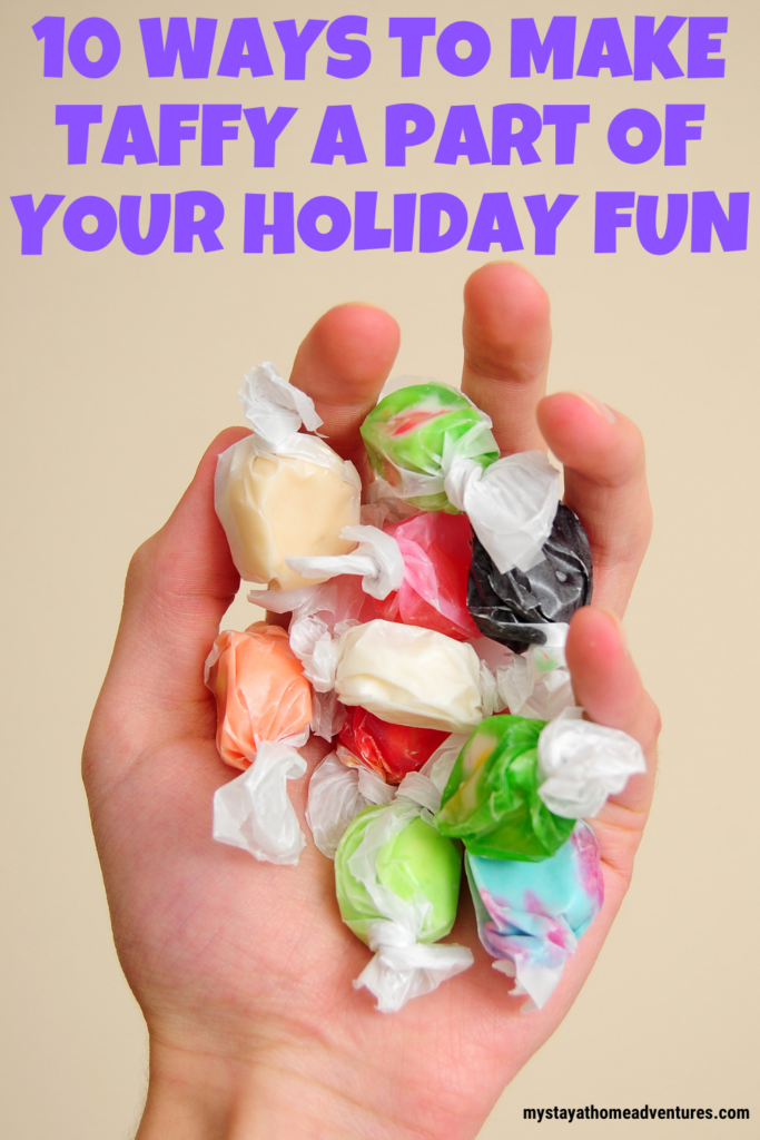  A hand holding a mix of colorful wrapped taffy candies, showcasing a fun way to incorporate sweet treats into holiday traditions.