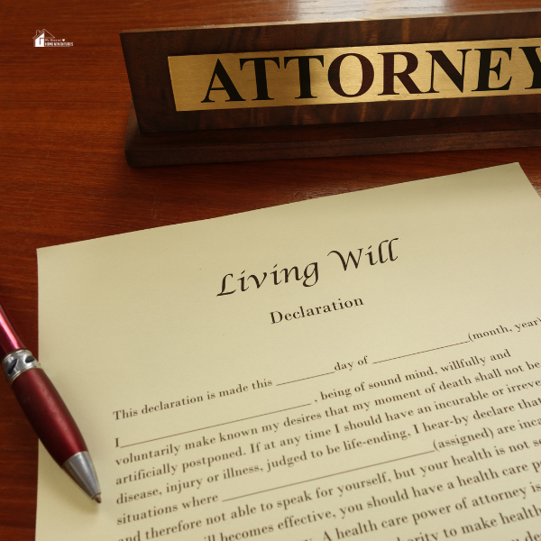 A "Living Will" declaration document next to a pen and an attorney's nameplate on a desk, illustrating steps in living will planning for stay-at-home moms.