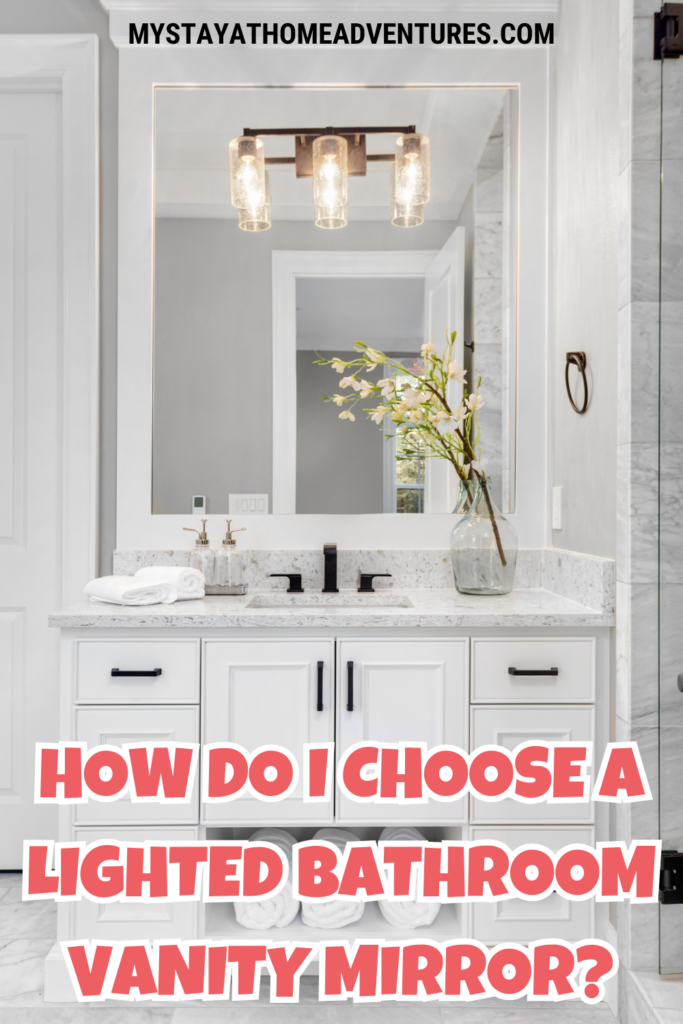 A modern bathroom vanity with a rectangular lighted mirror and a decorative vase of flowers on the countertop.