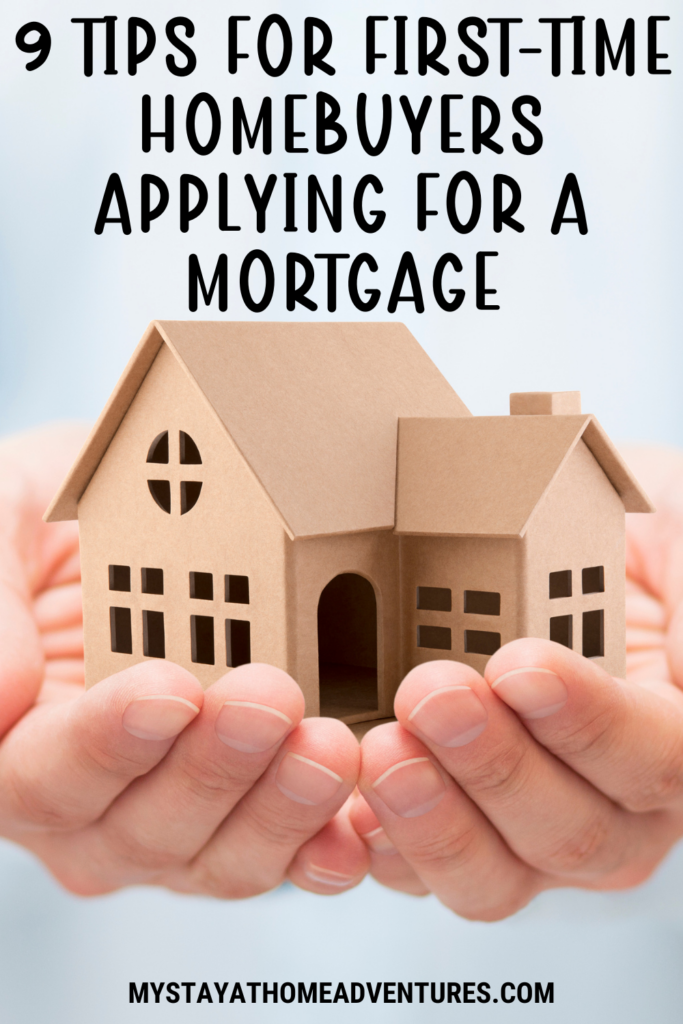 A pair of hands gently cradling a cardboard model of a house, symbolizing homeownership or mortgage application.