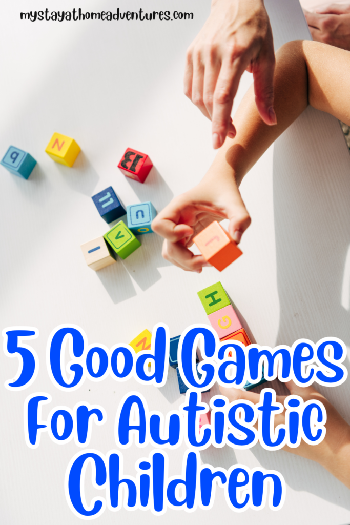 A child playing with colorful alphabet blocks on a white table, showcasing engaging and educational games for autistic children to develop motor skills and focus.