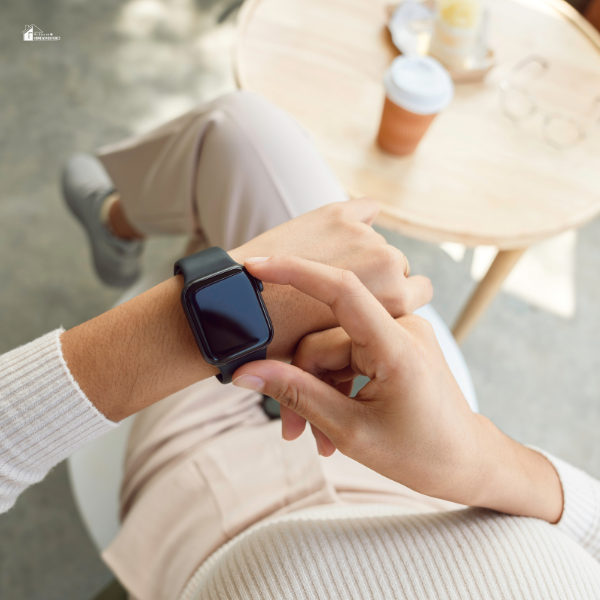 A person using a smartwatch, emphasizing wearable technology as an option for fall detection in Canada.