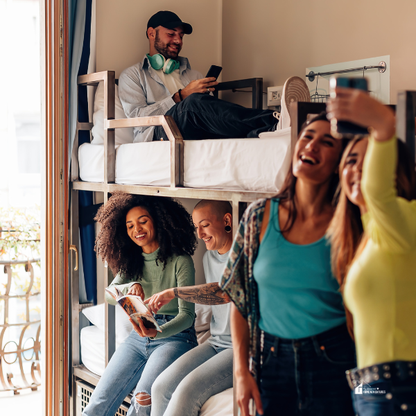 A group of roommates spending time together in a shared bunk-bed space, illustrating the social dynamics of renting with strangers.