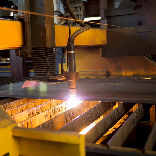 A powerful laser cutter in operation on a metal surface, illustrating its capability as an essential tool for intricate and detailed home crafting.