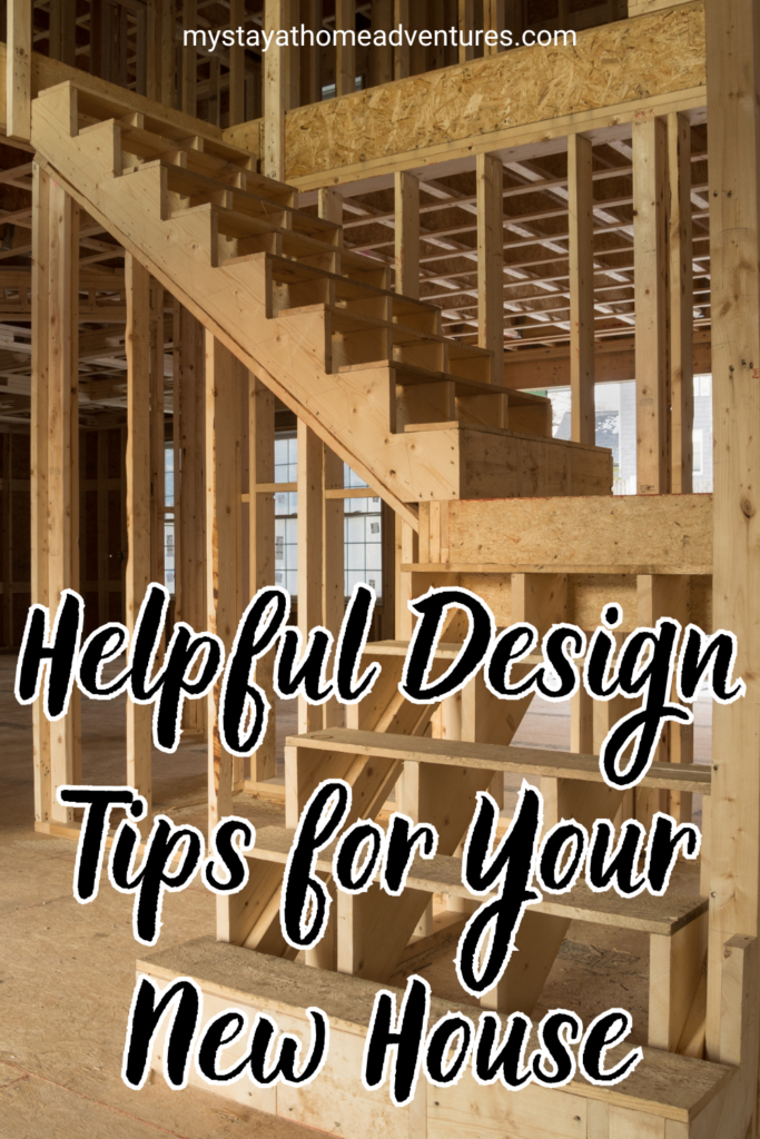 An unfinished wooden staircase inside a house under construction, showcasing exposed framing and structural details.