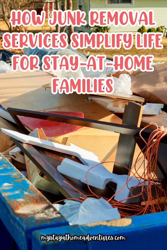 A close-up of a dumpster filled with various junk items, including wood, plastic, and red wire, set outdoors in a residential area.