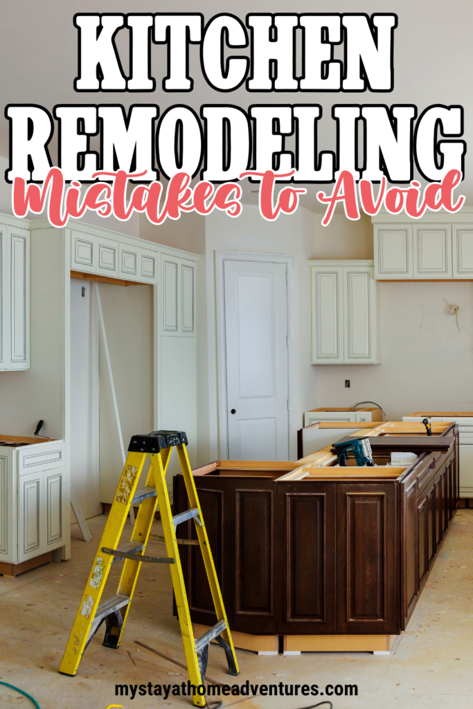 A partially completed kitchen remodel featuring a ladder, tools, and newly installed cabinets.