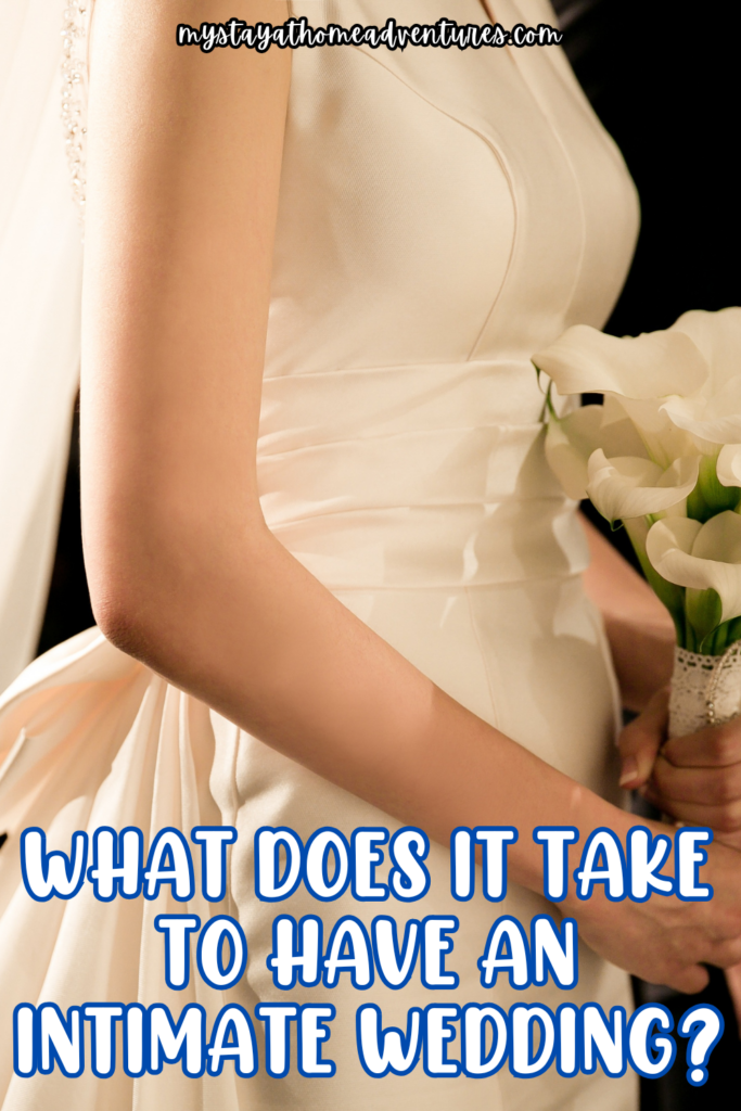 A bride in an elegant white dress holding a bouquet of white calla lilies, showcasing a simple and intimate wedding style.