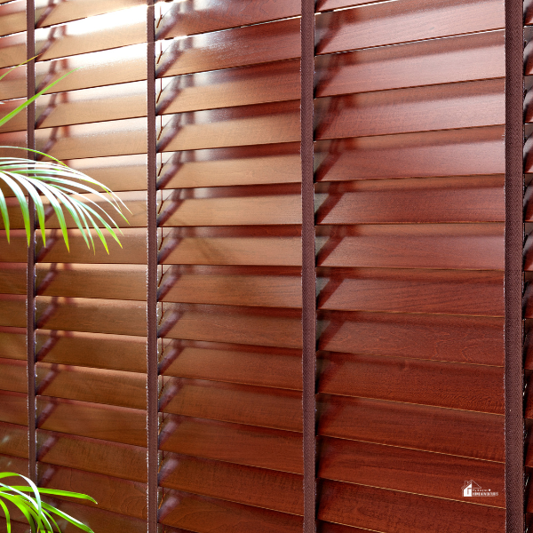 A set of dark wooden blinds with horizontal slats partially covering a window, adding warmth and privacy to a modern room.