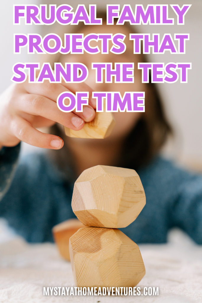 A child carefully stacking wooden geometric blocks on a table, focusing on balance and coordination.