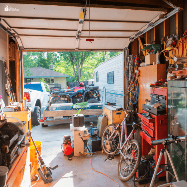 A cluttered garage filled with tools, bikes, and equipment, showing the need for better organization and remodeling for efficiency.