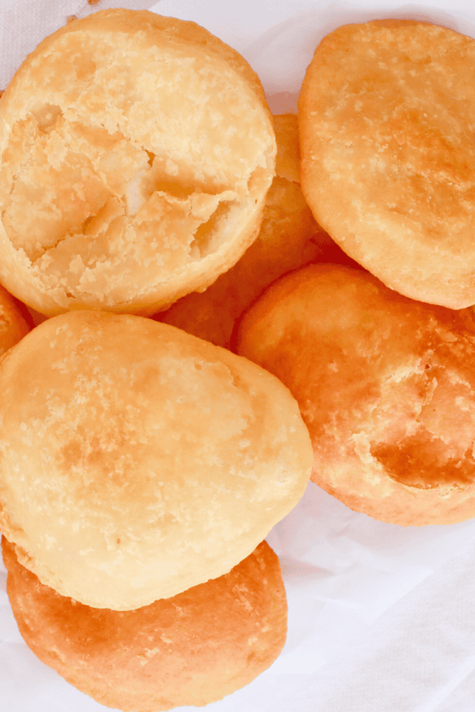 A close-up of traditional Puerto Rican arepas, highlighting their crispy, golden crust and soft, airy interior, perfect for pairing with stews, beans, or savory fillings.